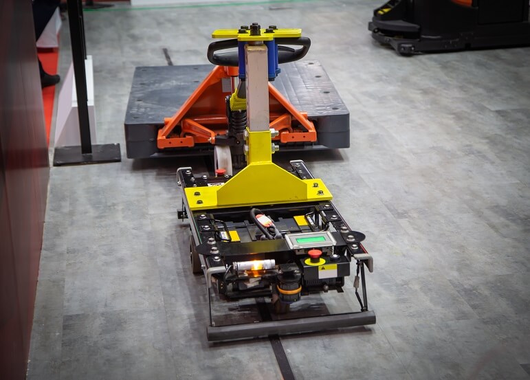 Forked Automatic Guided Vehicles (AGV) handling material in warehouse