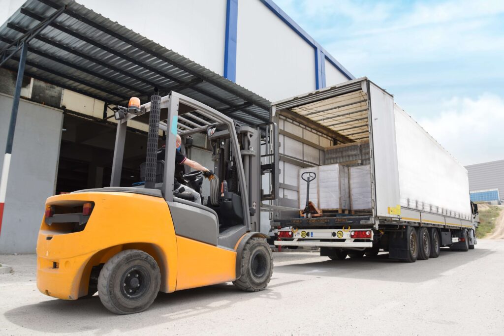Man using a forklift to unload a lorry at a warehouse stock turnover inventory turnover stock turn