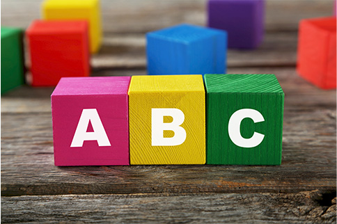 Pink, yellow and green wooden blocks displaying A, B and C on a wooden table. 

Reducing inventory levels with ABC classification ABC analysis